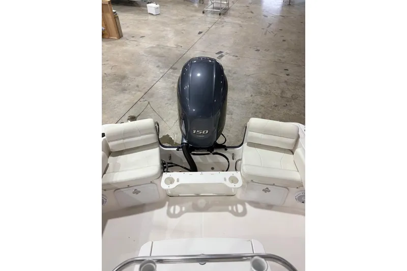 Slide: The Image of 2021 Edgewater 188CC boat interior with Yamaha 150 engine in a showroom. - 13