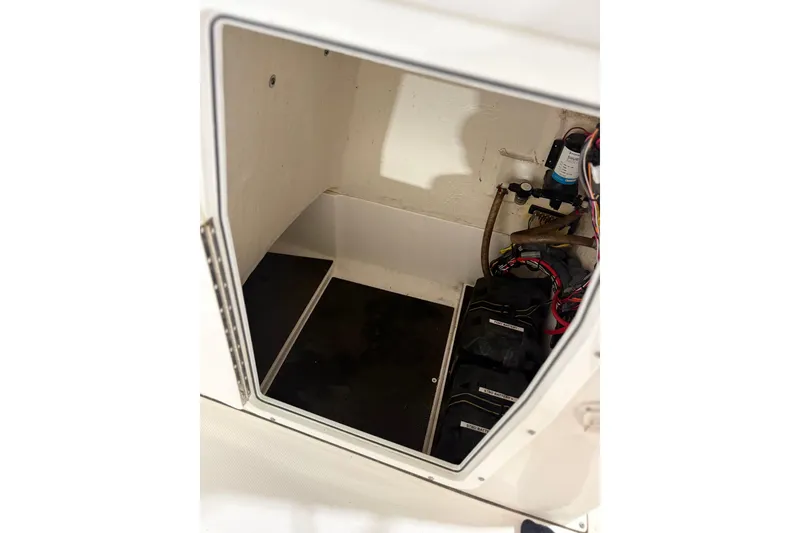 Slide: The Image of 2021 Edgewater 188CC boat storage compartment with wiring and equipment. - 15