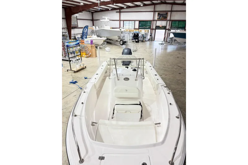 Slide: The Image of 2021 Edgewater 188CC boat displayed in a spacious indoor showroom. - 5