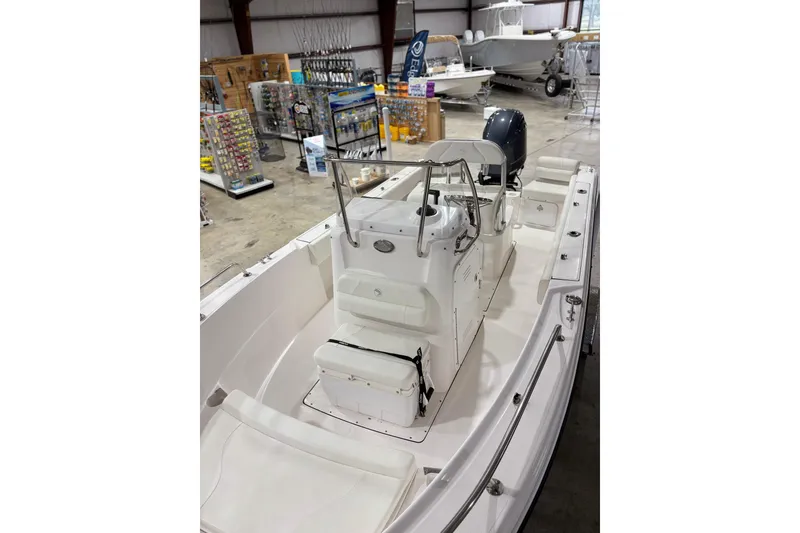 Slide: The Image of 2021 Edgewater 188CC boat interior in showroom with fishing gear displays. - 6