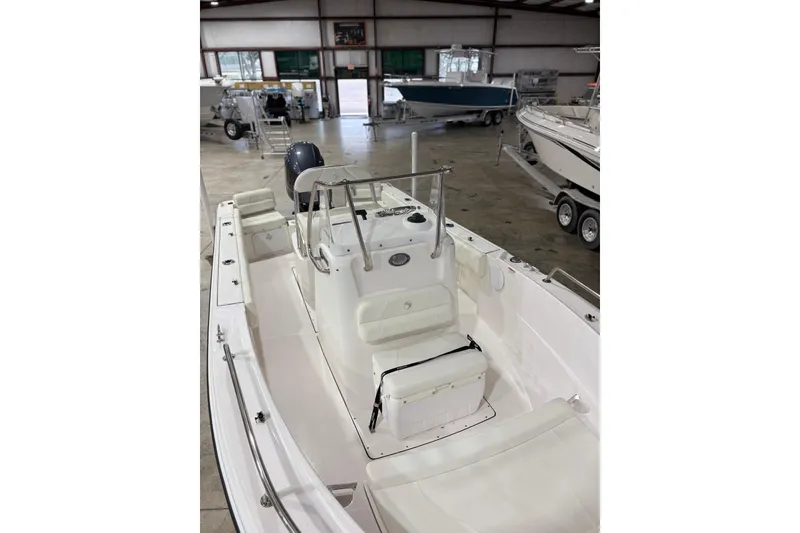 Slide: The Image of 2021 Edgewater 188CC boat interior in showroom, featuring center console and seating. - 7