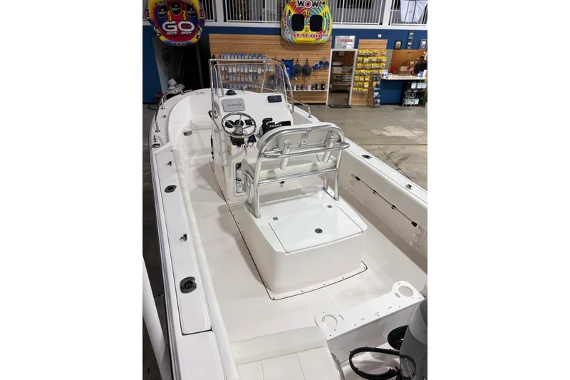Slide: The Image of 2021 Edgewater 188CC boat interior with console and seating in showroom. - 8