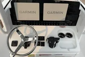 Slide: The Image of 2026 Sea Hunt Gamefish 25 dashboard with Garmin displays and steering wheel. - 10