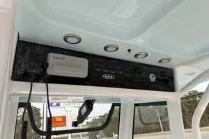 Slide: The Image of 2026 Sea Hunt Gamefish 25 boat interior with control panel and overhead lighting. - 13