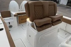 Slide: The Image of 2026 Sea Hunt Gamefish 25 boat interior with cushioned seating and storage compartments. - 8
