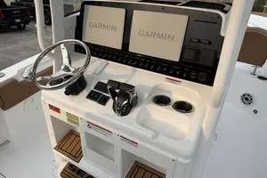 Slide: The Image of 2026 Sea Hunt Gamefish 25 helm with dual Garmin displays and steering wheel. - 9