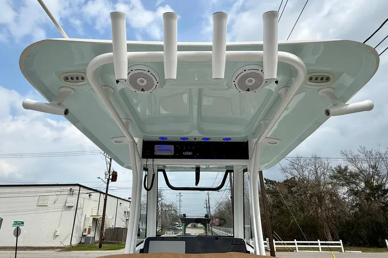 Slide: The Image of 2022 Sea Hunt Ultra 265 SE boat with rod holders and speakers on the T-top. - 11