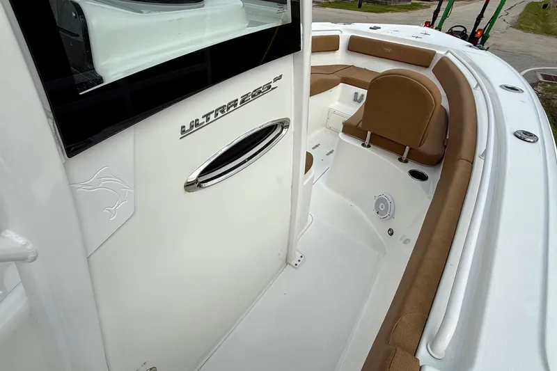 Slide: The Image of 2022 Sea Hunt Ultra 265 SE boat interior with tan seating and sleek design. - 15
