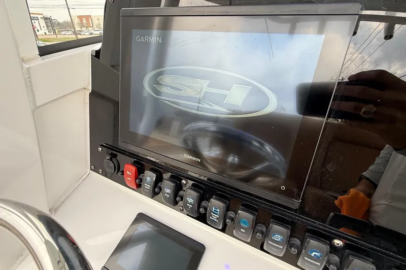 Slide: The Image of Control panel of 2022 Sea Hunt Ultra 265 SE boat with Garmin display. - 17