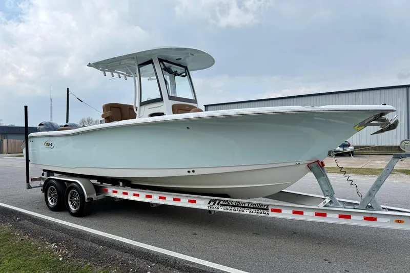 Slide: The Image of 2022 Sea Hunt Ultra 265 SE boat on trailer, parked outdoors. - 5