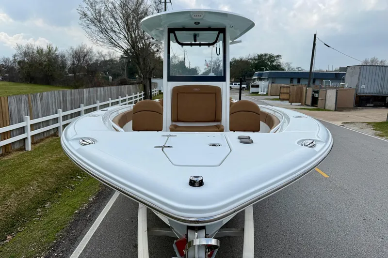 Slide: The Image of 2022 Sea Hunt Ultra 265 SE boat on trailer, parked on a road. - 6