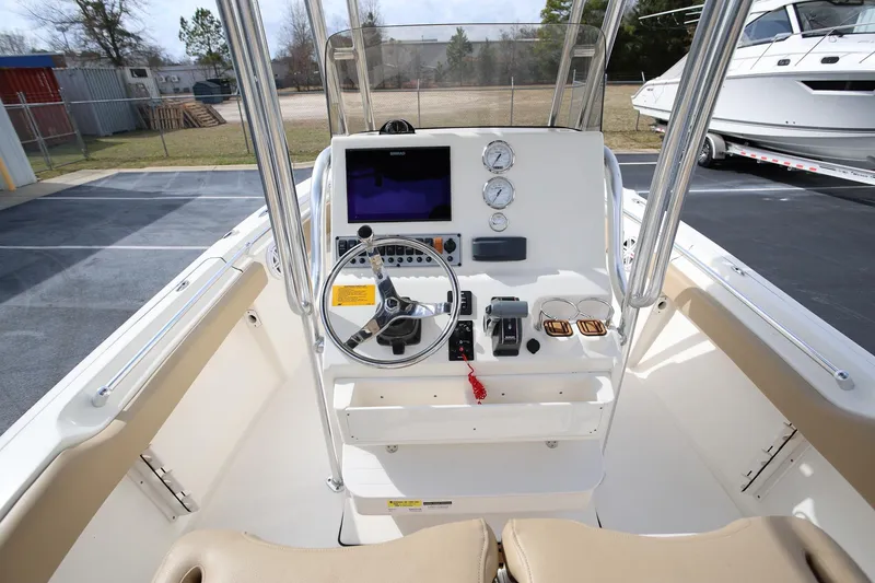 Slide: The Image of 2015 Key West 219 FS boat console with steering wheel and gauges. - 11