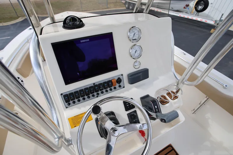 Slide: The Image of 2015 Key West 219 FS boat dashboard with Simrad display and gauges. - 12