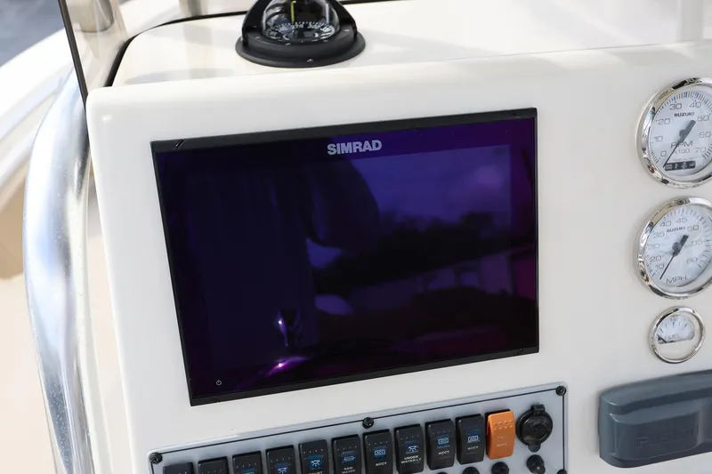 Slide: The Image of Control panel of 2015 Key West 219 FS boat with Simrad display and gauges. - 13