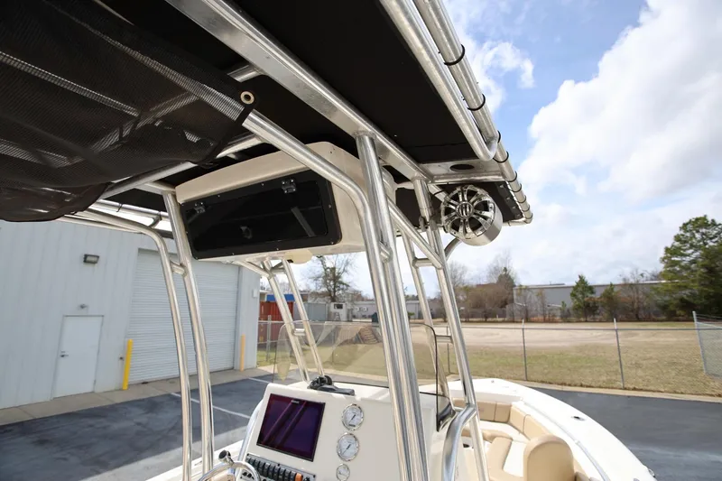 Slide: The Image of 2015 Key West 219 FS boat with T-top and console, outdoor setting. - 16