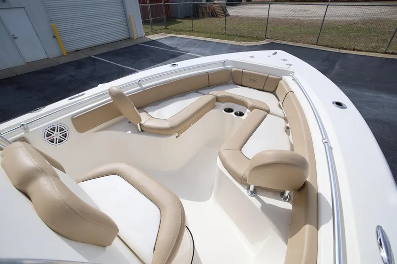 Slide: The Image of 2015 Key West 219 FS boat interior with beige seating and cup holders. - 17