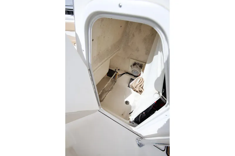 Slide: The Image of 2015 Key West 219 FS boat storage compartment with rope and equipment. - 21