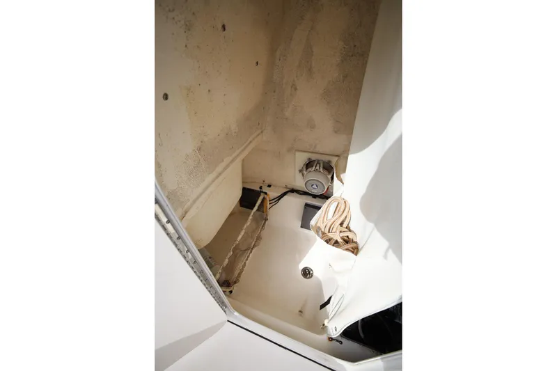 Slide: The Image of Storage compartment of 2015 Key West 219 FS boat with rope and speaker. - 22
