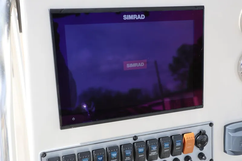 Slide: The Image of Simrad display on 2015 Key West 219 FS boat dashboard with control panel. - 23