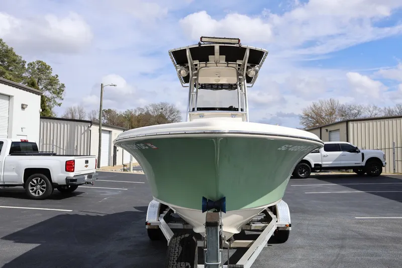Slide: The Image of 2015 Key West 219 FS boat on trailer, parked near trucks. - 5
