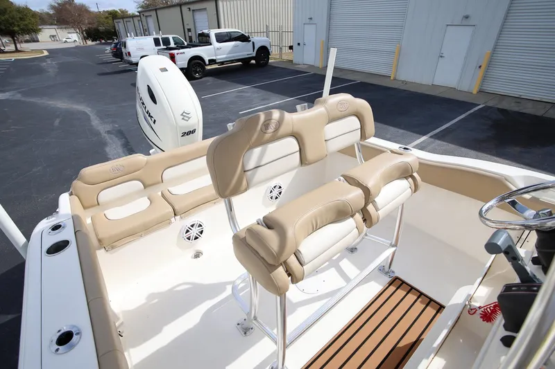 Slide: The Image of 2015 Key West 219 FS boat interior with beige seating and Suzuki engine. - 9