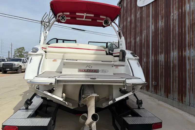 Slide: The Image of 2017 Cobalt R3 WSS Surf boat with red canopy on trailer, rear view. - 3