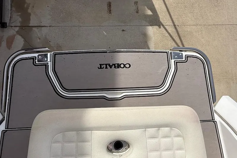 Slide: The Image of 2017 Cobalt R3 WSS Surf boat deck with logo, featuring cushioned seating. - 4