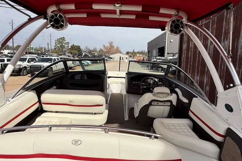 Slide: The Image of 2017 Cobalt R3 WSS Surf boat interior with red and white seating, parked outdoors. - 6
