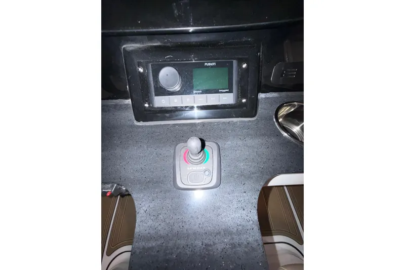 Slide: The Image of Control panel of 2026 Monterey Elite 25 SD boat with joystick and display. - 3