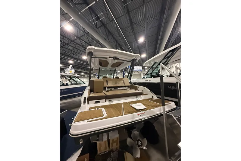 Slide: The Image of 2026 Monterey Elite 25 SD boat displayed indoors, showcasing sleek design and spacious seating. - 4