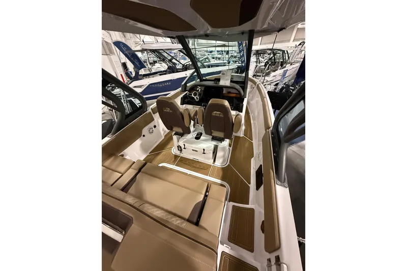 Slide: The Image of 2026 Monterey Elite 25 SD boat interior with tan seating and modern design. - 6