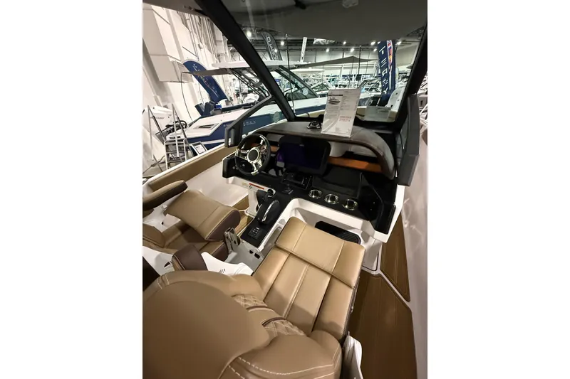 Slide: The Image of Interior view of 2026 Monterey Elite 25 SD boat with luxurious seating and modern dashboard. - 7
