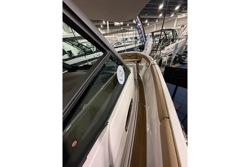 Slide: The Image of 2026 Monterey Elite 25 SD boat interior at a showroom display. - 8