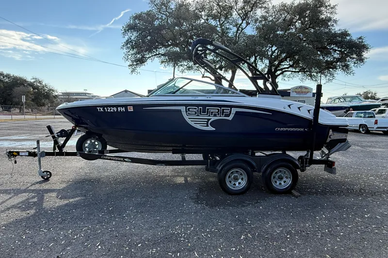 The Image of 2019 Chaparral 21 H2O Surf boat on trailer, parked outdoors. - 0