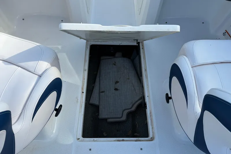 Slide: The Image of 2019 Chaparral 21 H2O Surf boat interior storage compartment with open hatch. - 10