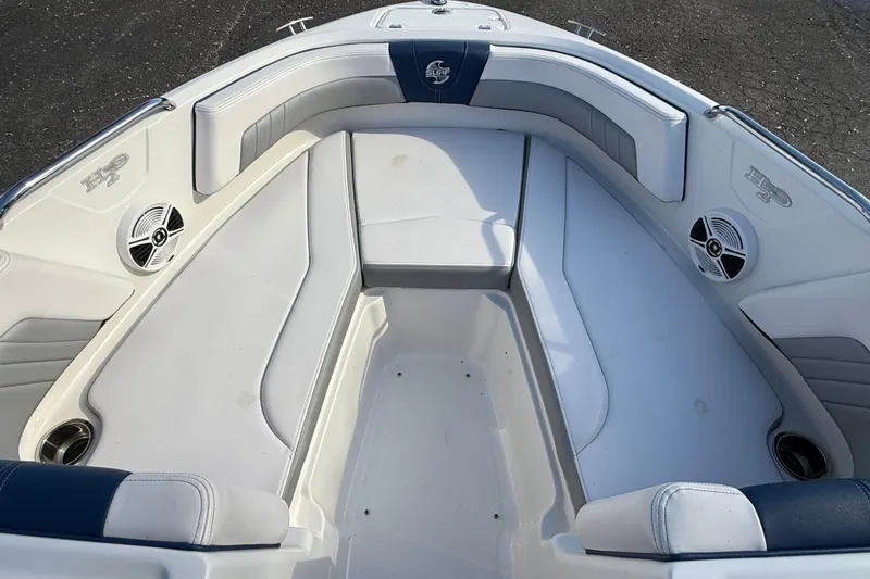 Slide: The Image of 2019 Chaparral 21 H2O Surf boat interior with cushioned seating and speakers. - 13