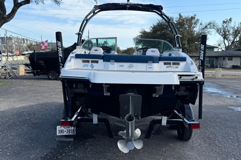 Slide: The Image of 2019 Chaparral 21 H2O Surf boat, rear view, parked outdoors. - 3