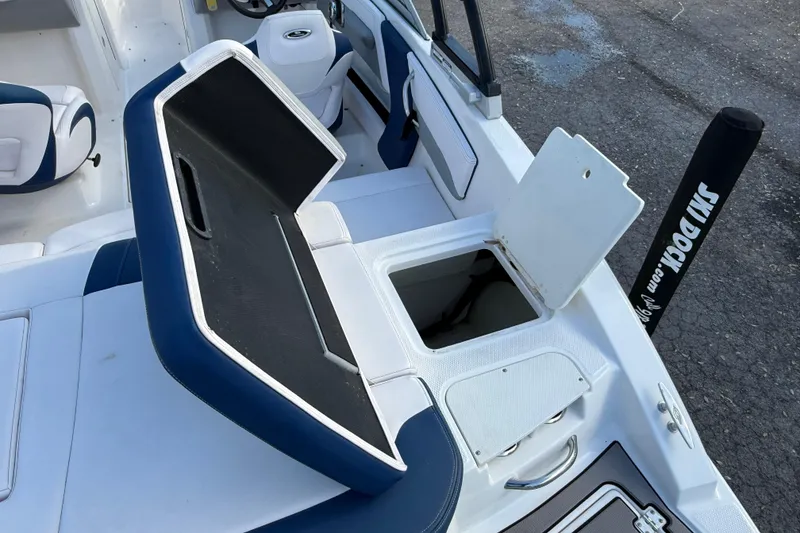 Slide: The Image of 2019 Chaparral 21 H2O Surf boat interior with open storage compartments. - 6