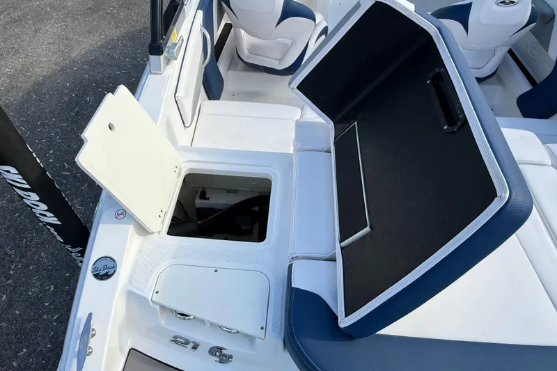 Slide: The Image of 2019 Chaparral 21 H2O Surf boat interior with open storage compartments. - 7