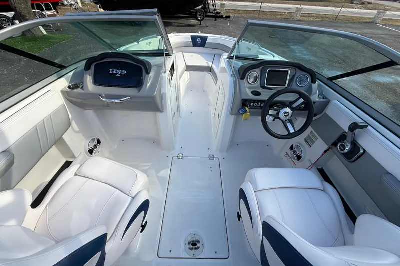 Slide: The Image of 2019 Chaparral 21 H2O Surf boat interior with steering wheel and seating. - 8