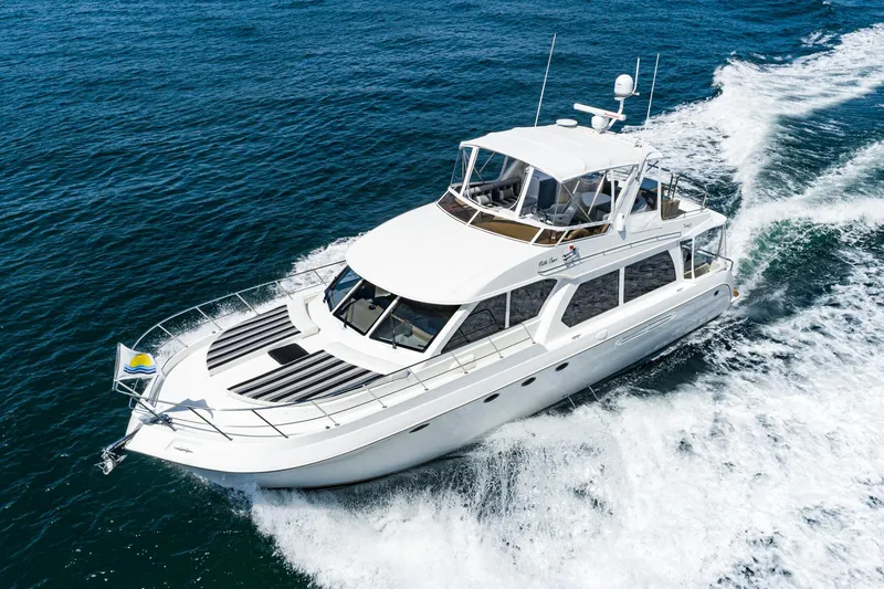 Slide: The Image of Luxury 2006 Navigator 5100 yacht cruising on open water. - 1