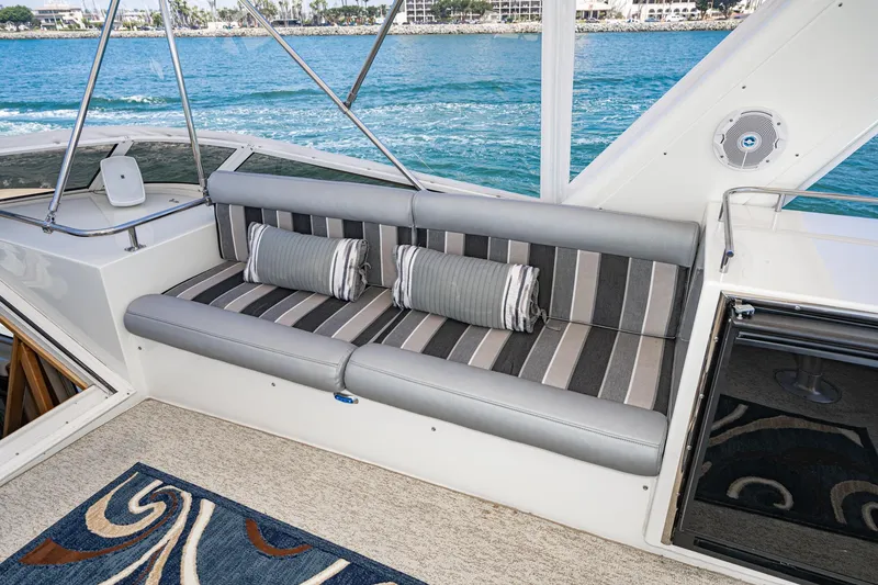 Slide: The Image of Luxurious seating area on 2006 Navigator 5100 yacht with striped cushions and ocean view. - 22