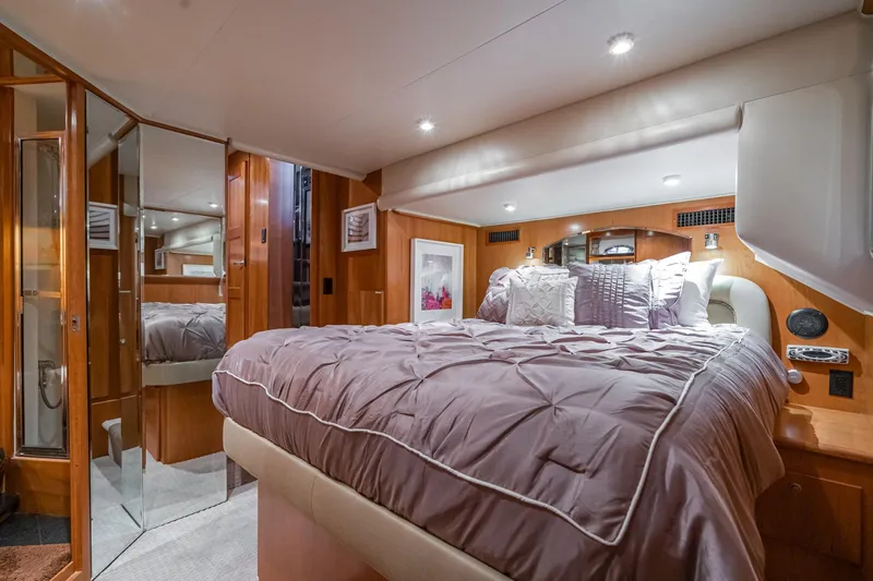 Slide: The Image of Luxurious bedroom interior of 2006 Navigator 5100 yacht with plush bedding and wood accents. - 29