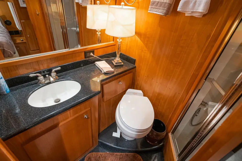 Slide: The Image of Luxurious 2006 Navigator 5100 yacht bathroom with wood paneling, granite countertop, and modern fixtures. - 36