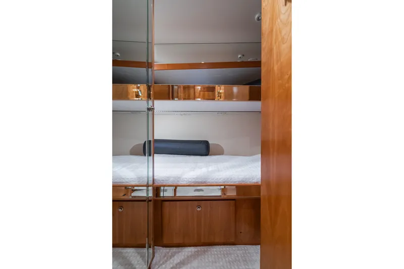 Slide: The Image of Interior of 2006 Navigator 5100 yacht with wooden cabinetry and cozy bedding. - 40