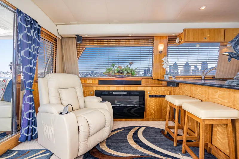 Slide: The Image of Luxurious interior of 2006 Navigator 5100 yacht with recliner and bar stools. - 7