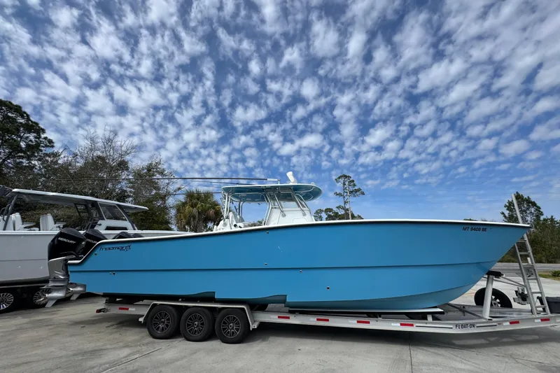 Slide: The Image of Blue 2016 Freeman 37VH boat on trailer under cloudy sky. - 10