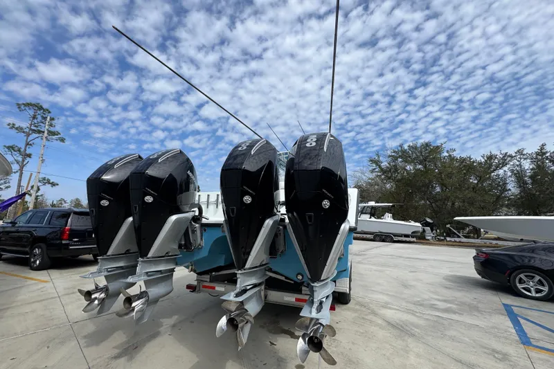 Slide: The Image of 2016 Freeman 37VH boat with triple outboard motors in a parking lot under a cloudy sky. - 14