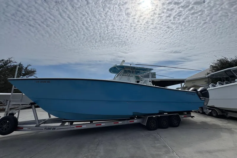 Slide: The Image of 2016 Freeman 37VH boat on trailer under cloudy sky. - 2