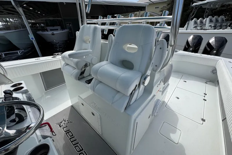 Slide: The Image of Luxury seating on a 2016 Freeman 37VH boat, featuring dual white captain chairs. - 28